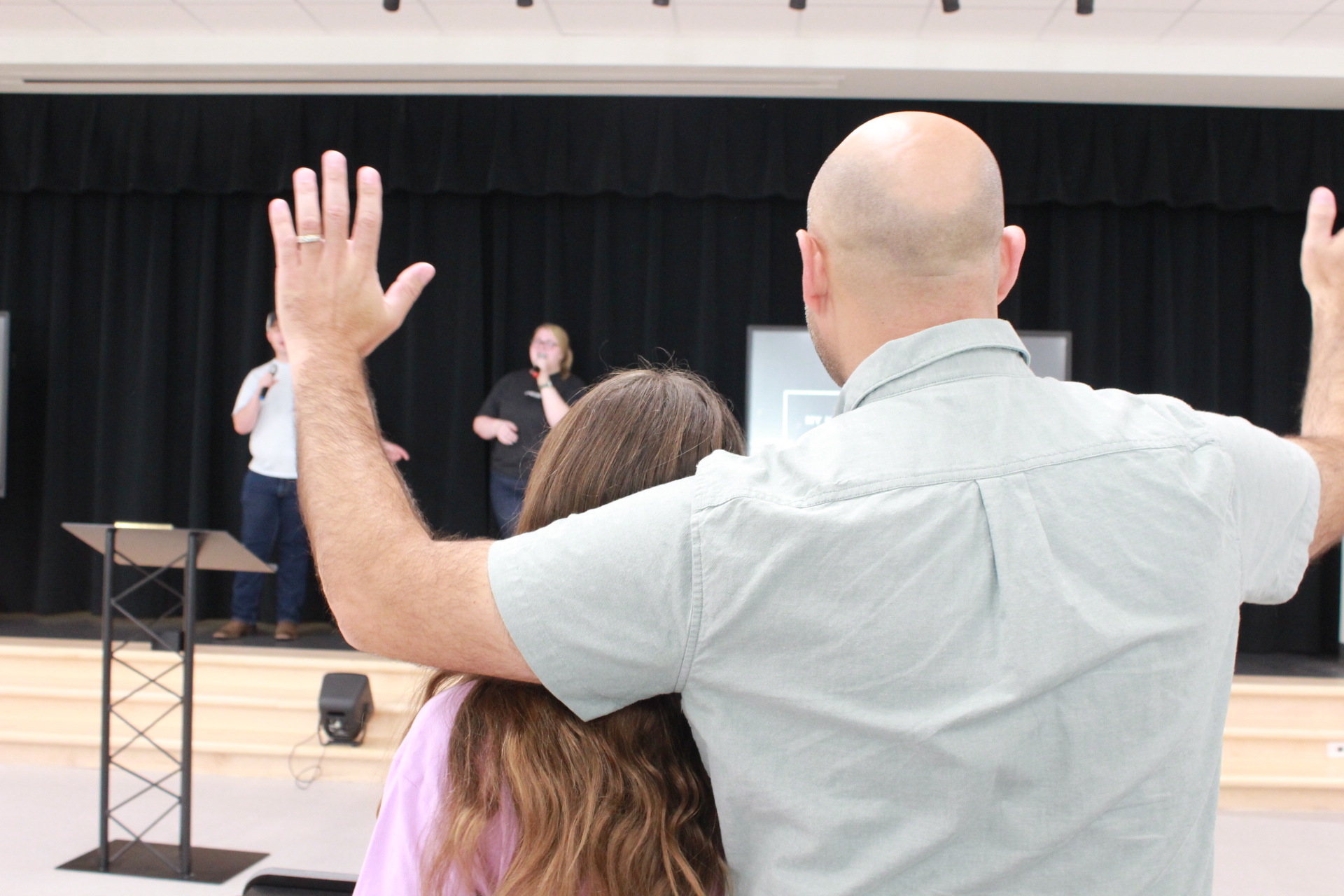Father and daughter worshipping together at Arise Church South Lake